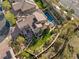 Aerial view of a home's backyard pool, green landscaping, solar panels, and stone patio at 541 Green Sage Way, Las Vegas, NV 89138