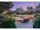 Tranquil backyard patio with comfortable seating, fire pit, pool, spa, and lush plants at 541 Green Sage Way, Las Vegas, NV 89138