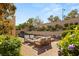 Secluded backyard with patio furniture, lush landscaping, and brick hardscape at 541 Green Sage Way, Las Vegas, NV 89138