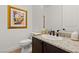 Chic half-bath featuring granite counters, dark wood vanity, and stylish decor at 541 Green Sage Way, Las Vegas, NV 89138