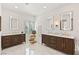 A large, bright bathroom with marble floors, dual vanities, mirrors, and gold accents at 541 Green Sage Way, Las Vegas, NV 89138