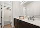 Bathroom with double sinks, dark cabinets, and a tub with shower at 541 Green Sage Way, Las Vegas, NV 89138