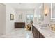 A large, bright bathroom with marble floors, dual vanities, mirrors, and gold accents at 541 Green Sage Way, Las Vegas, NV 89138