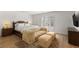 Spacious bedroom featuring a carved wood bed, sofa, and ample natural light from the nearby windows at 541 Green Sage Way, Las Vegas, NV 89138