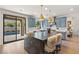 Bright kitchen featuring a large island, blue cabinets, and access to the outdoor patio at 541 Green Sage Way, Las Vegas, NV 89138