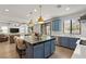 Open kitchen showcasing a large island with seating, stainless appliances, and outdoor access at 541 Green Sage Way, Las Vegas, NV 89138