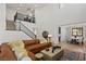 Open-concept living room with modern decor, hardwood floors, and a staircase leading to a loft area at 541 Green Sage Way, Las Vegas, NV 89138
