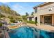 Pool and spa surrounded by lush landscaping and a covered patio of the home at 541 Green Sage Way, Las Vegas, NV 89138