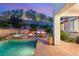 Backyard oasis with a pool, spa, cozy seating area, and lush landscaping at 541 Green Sage Way, Las Vegas, NV 89138