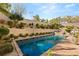 Sparkling pool surrounded by lush landscaping and brick patio at 541 Green Sage Way, Las Vegas, NV 89138