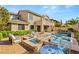 Elegant outdoor living space featuring a pool, hot tub, and fire pit at 541 Green Sage Way, Las Vegas, NV 89138