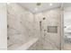 A bright, spacious marble shower enclosure featuring dual shower heads, bench, and a built-in shelf at 541 Green Sage Way, Las Vegas, NV 89138