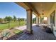 Expansive back patio overlooking the greenbelt, complete with a table and columns at 5524 E San Pietro Dr, Pahrump, NV 89061