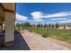 Inviting back patio with pavers, manicured lawn view, and stylish outdoor living space at 5524 E San Pietro Dr, Pahrump, NV 89061