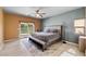 Main bedroom features a king bed, ceiling fan and sliding glass door leading to outdoor patio at 5524 E San Pietro Dr, Pahrump, NV 89061