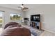 Bedroom featuring a window with backyard view, decorative ceiling fan, desk and comfortable beanbag seating at 5524 E San Pietro Dr, Pahrump, NV 89061