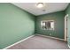 This bedroom features green walls, a window with natural light, and neutral carpeting at 5524 E San Pietro Dr, Pahrump, NV 89061