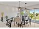 Dining area with modern lighting, outdoor access, and views of a fenced backyard at 5524 E San Pietro Dr, Pahrump, NV 89061