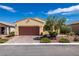 Charming single-story home featuring a well-maintained front yard and a two-car garage with brick-paved driveway at 5524 E San Pietro Dr, Pahrump, NV 89061