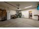 This garage features epoxy floors, fluorescent lighting, storage racks, and a side access door at 5524 E San Pietro Dr, Pahrump, NV 89061