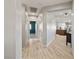 Bright hallway featuring hardwood floors and neutral paint, connecting various rooms including the kitchen at 5524 E San Pietro Dr, Pahrump, NV 89061