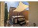 Private hot tub area shielded by a sunshade, creating a relaxing oasis in the backyard at 5524 E San Pietro Dr, Pahrump, NV 89061