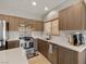 Well-lit kitchen showcasing stainless steel appliances, stylish backsplash, and light wood cabinetry at 5524 E San Pietro Dr, Pahrump, NV 89061