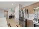 Bright kitchen featuring a stainless steel refrigerator, designer backsplash, and light wood cabinets at 5524 E San Pietro Dr, Pahrump, NV 89061