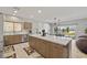 Bright kitchen with stainless steel appliances, light wood cabinets, and a large island with white countertop at 5524 E San Pietro Dr, Pahrump, NV 89061
