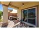 Relaxing covered patio featuring a hot tub, elegant brick flooring, and seamless indoor-outdoor living with sliding glass doors at 5524 E San Pietro Dr, Pahrump, NV 89061