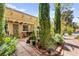 Charming backyard patio with a pergola, surrounded by lush landscaping and mature trees at 5612 Beach Mill Way, Las Vegas, NV 89130