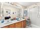 Bright bathroom featuring a dual vanity and a stand-up shower at 5612 Beach Mill Way, Las Vegas, NV 89130