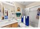 Bathroom featuring neutral colors, a tiled shower, and marble countertops at 5612 Beach Mill Way, Las Vegas, NV 89130