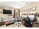 This bedroom has two desks, a bed, and a TV at 5612 Beach Mill Way, Las Vegas, NV 89130