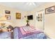 Cozy bedroom decorated with artwork, featuring a plush bed and a wall-mounted television at 5612 Beach Mill Way, Las Vegas, NV 89130
