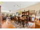 Open-concept dining area features a wooden table, chairs, ceiling fan, and seamless flow into the inviting living space at 5612 Beach Mill Way, Las Vegas, NV 89130