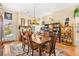 Elegant dining space featuring a wooden table, ornate chairs, and glass door offering views of the landscaped exterior at 5612 Beach Mill Way, Las Vegas, NV 89130