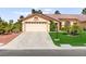 Well-maintained single-story home featuring a spacious driveway and manicured front lawn at 5612 Beach Mill Way, Las Vegas, NV 89130