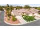 Aerial view of a well-maintained home featuring a pristine lawn, desert landscaping, and a two car garage at 5612 Beach Mill Way, Las Vegas, NV 89130