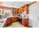 Modern kitchen showcasing wooden cabinets, stainless steel appliances, and quartz countertops at 5612 Beach Mill Way, Las Vegas, NV 89130