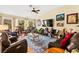 Inviting living room with vaulted ceilings, warm color palette, and comfortable seating arrangement at 5612 Beach Mill Way, Las Vegas, NV 89130