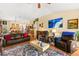 Charming living room featuring hardwood floors, comfortable seating, and an open layout to the dining area at 5612 Beach Mill Way, Las Vegas, NV 89130