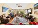 Relaxing living room featuring comfortable seating, hardwood floors, and large windows to enjoy outdoor view at 5612 Beach Mill Way, Las Vegas, NV 89130