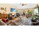 Inviting living room featuring comfortable seating, a cozy atmosphere, and ample natural light through large windows at 5612 Beach Mill Way, Las Vegas, NV 89130