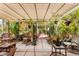 Relaxing outdoor patio area with shaded pergola, lovely foliage, and wicker seating at 5612 Beach Mill Way, Las Vegas, NV 89130