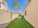 Low-maintenance backyard featuring artificial turf, a palm tree, privacy walls, and mountain views beyond at 566 Searchlight Dr, Las Vegas, NV 89110