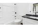 Bathroom with tub, black hardware, and black and white stone counter at 566 Searchlight Dr, Las Vegas, NV 89110