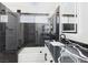Bathroom features an elegant vanity with dual sinks, marbled countertops, and a glass-enclosed shower at 566 Searchlight Dr, Las Vegas, NV 89110