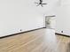 Bright bedroom featuring hardwood floors, ceiling fan, and sliding door to the backyard at 566 Searchlight Dr, Las Vegas, NV 89110
