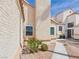 Close-up of a home's stucco exterior, showcasing desert landscaping and a well-maintained walkway at 566 Searchlight Dr, Las Vegas, NV 89110